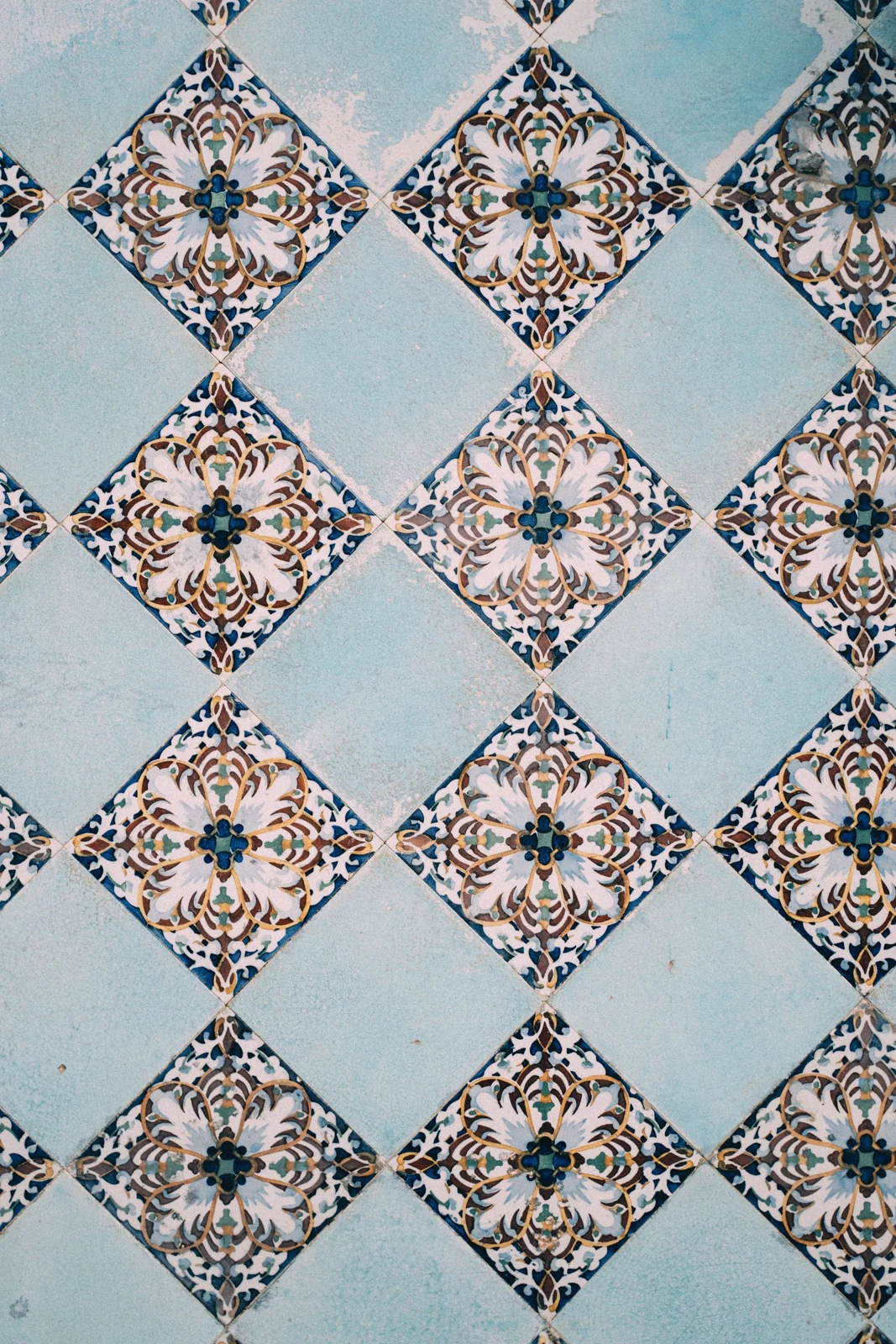 A detailed view of elegant blue and white geometric tiles creating a classic pattern
