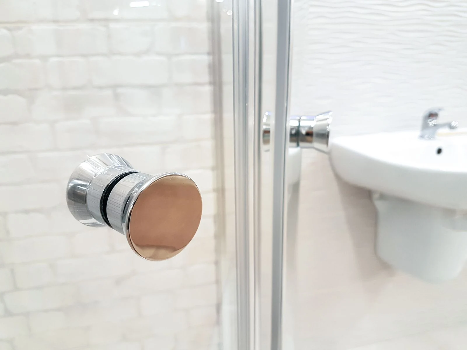 Contemporary bathroom interior featuring glass shower and sleek sink design